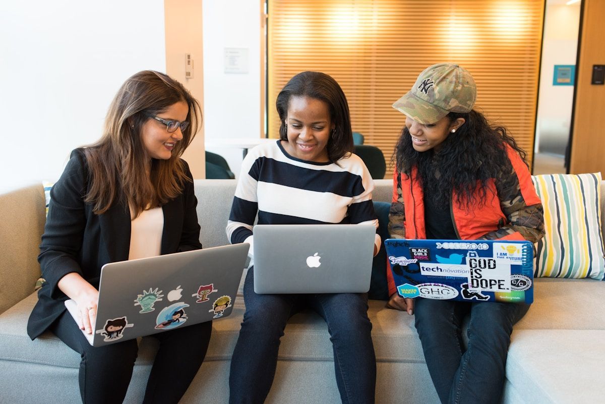 Women collaborating on laptops